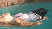 swimming in white top and jeans in water